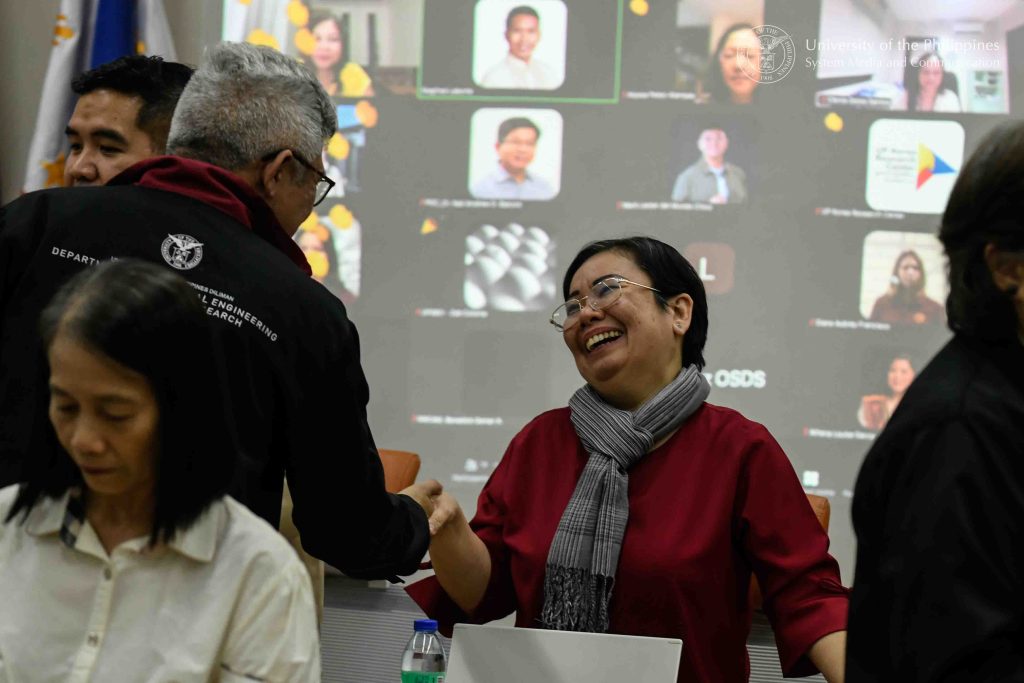 Auditor Romelia Constancia Mendina of the TÜV Nord Philippines audit team (right) shakes hands with Asst. Prof. Jose Emmanuel Reverente, deputy director of the UP System Technology Transfer and Business Development Office (left). Photo by Kevin Roque, UPS-MCO.