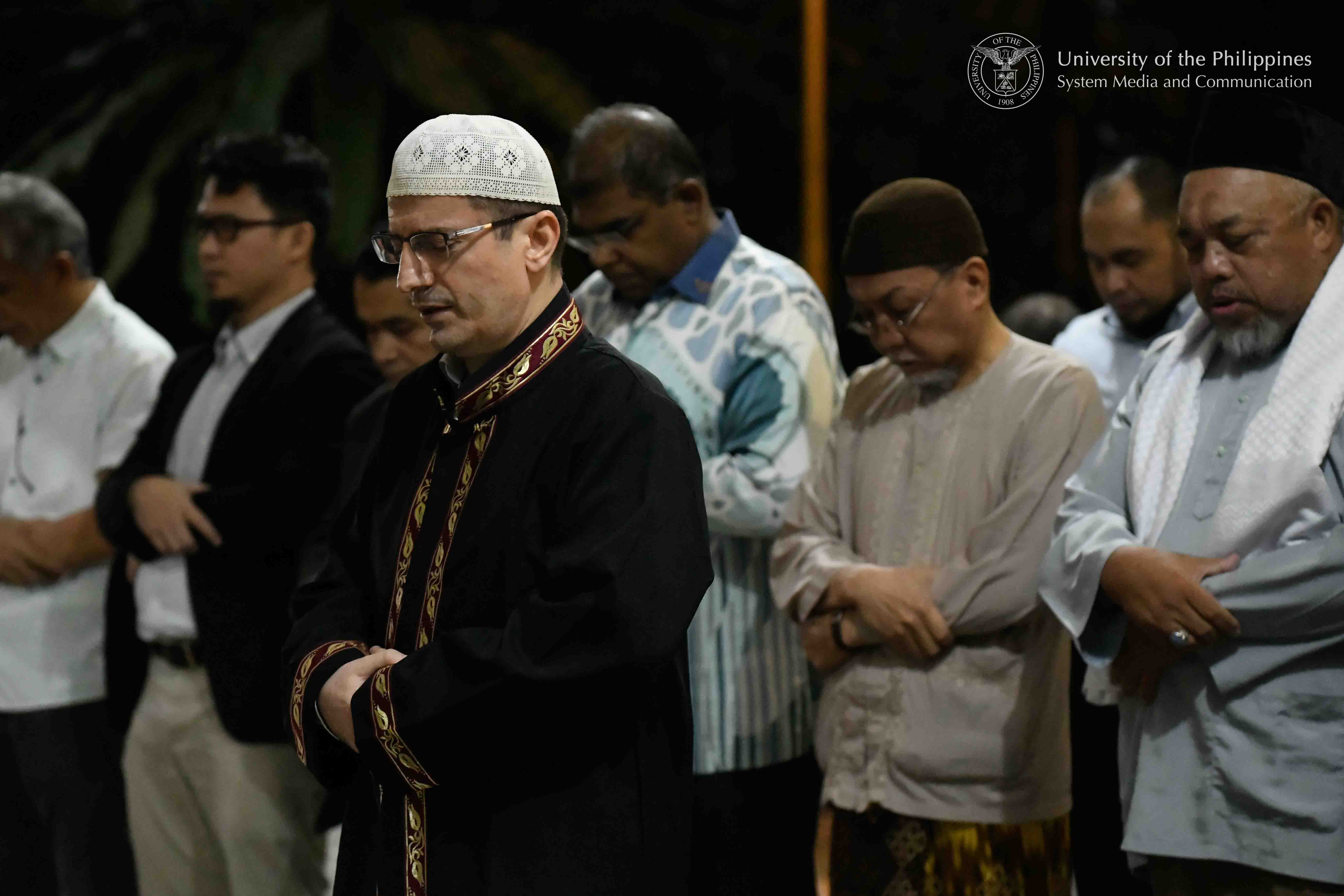 Dr. Abdulhamit Durakoglu (wearing white taqiyah), spiritual adviser at the Harmony and Wisdom Foundation, Inc. and a lecturer at the UP Institute of Islamic Studies, leads the community prayer held at sunset, March 17 at the Executive House in UP Diliman. Photo by Kevin Roque, UPS-MCO.