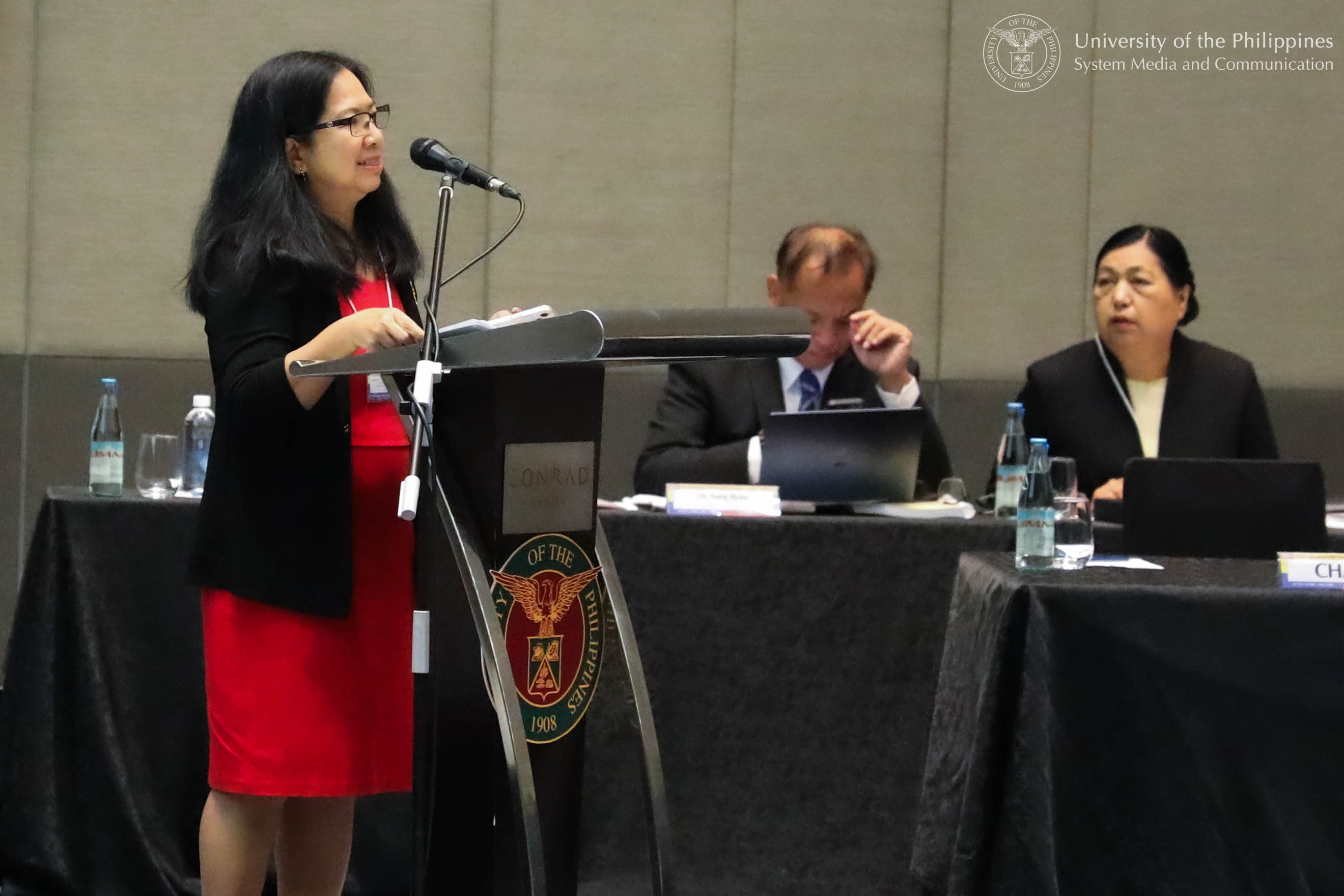 UP Center for Integrative Development Studies Executive Director Rosalie Arcala Hall (standing) introduces the guest officials in the symposium’s opening session.
Photo by Jun Madrid, UPS-MCO.