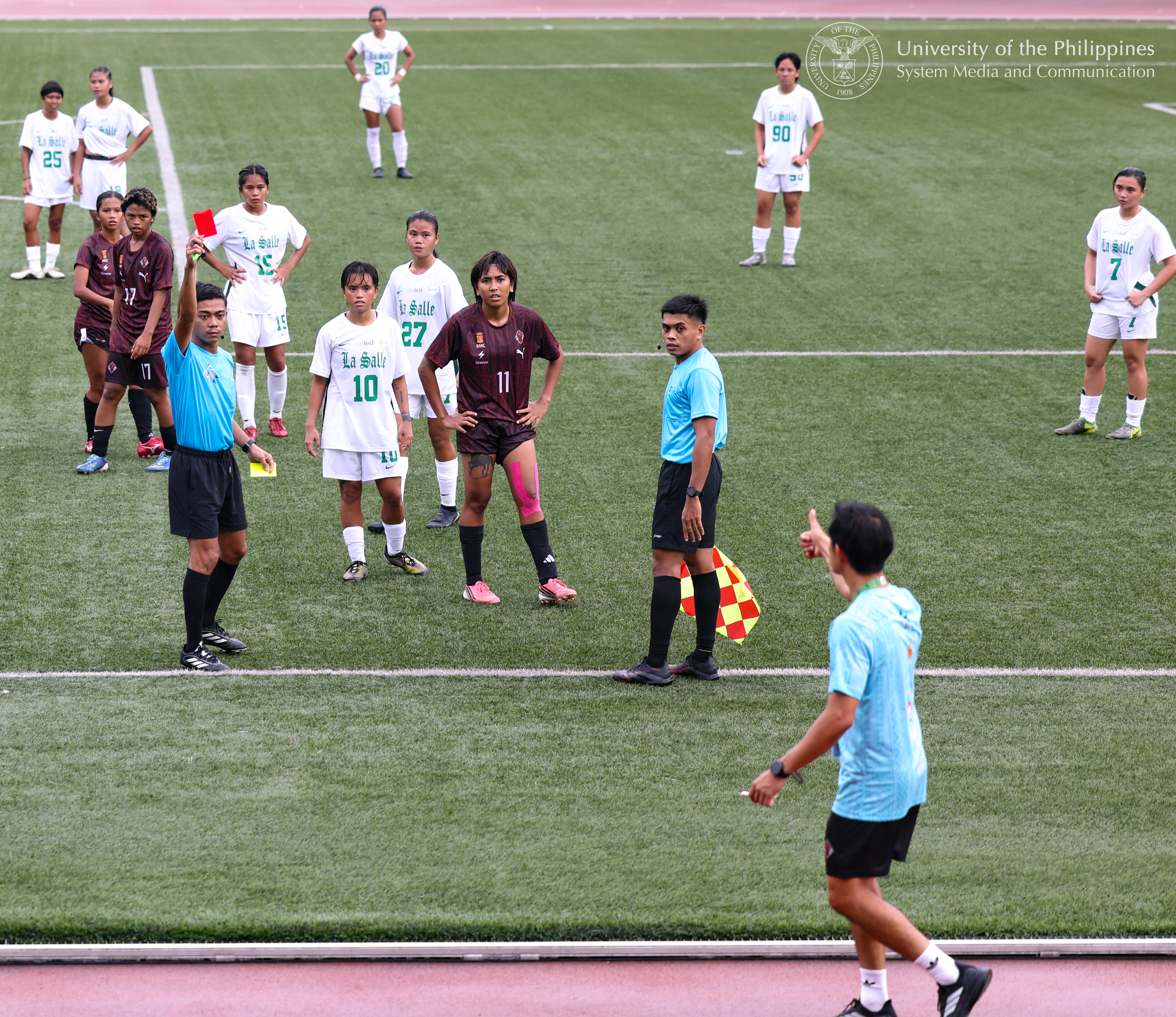 Seeing red. UPWFT Head Coach Anto Gonzales (bottom right) yields after two consecutive yellow cards that equal a red card and immediate ejection from the playing field.
Photo by Misael Bacani, UPS-MCO.